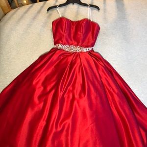 Red strapless ballgown with a sparkle belt